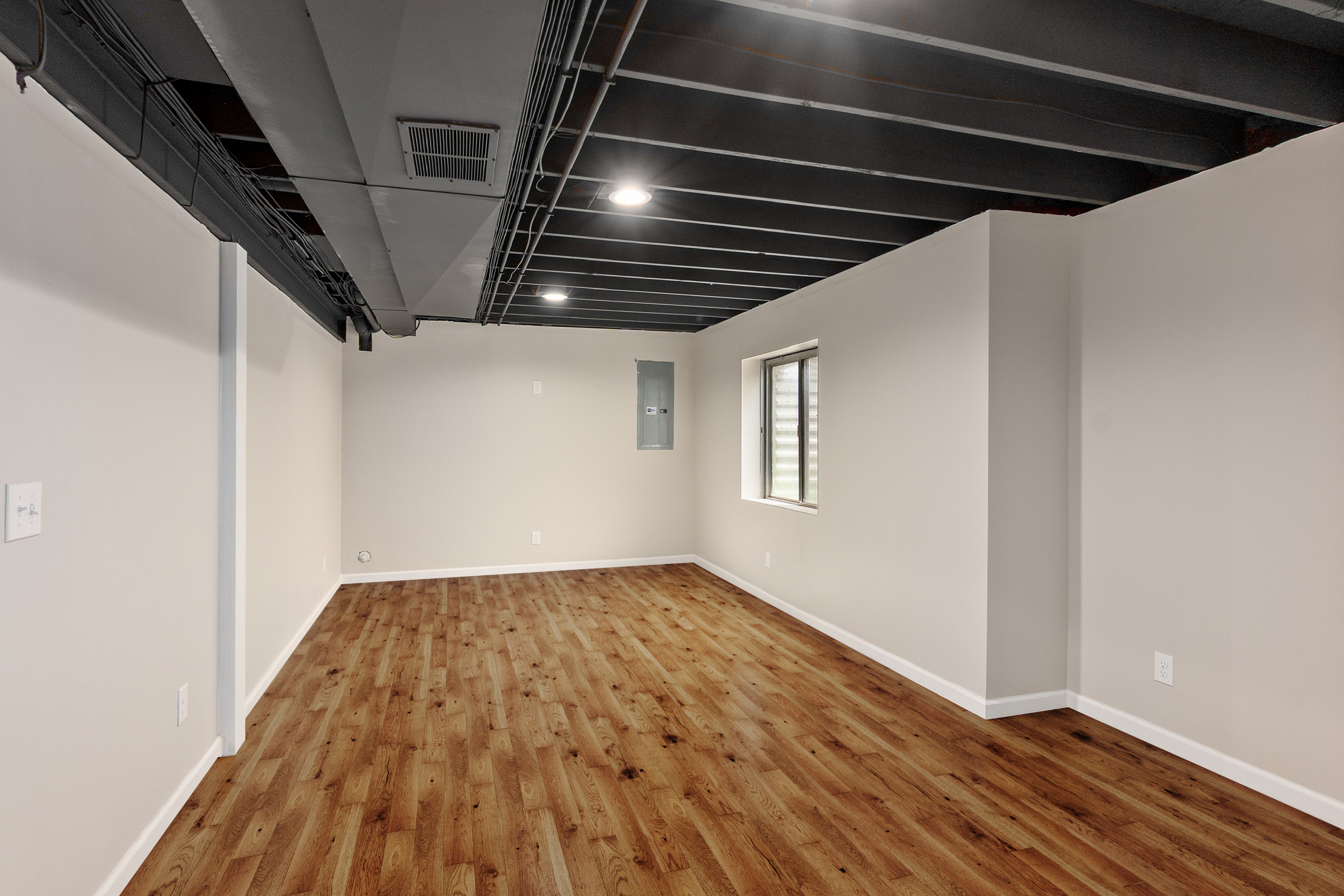 Finished basement living area opening toward the hallway