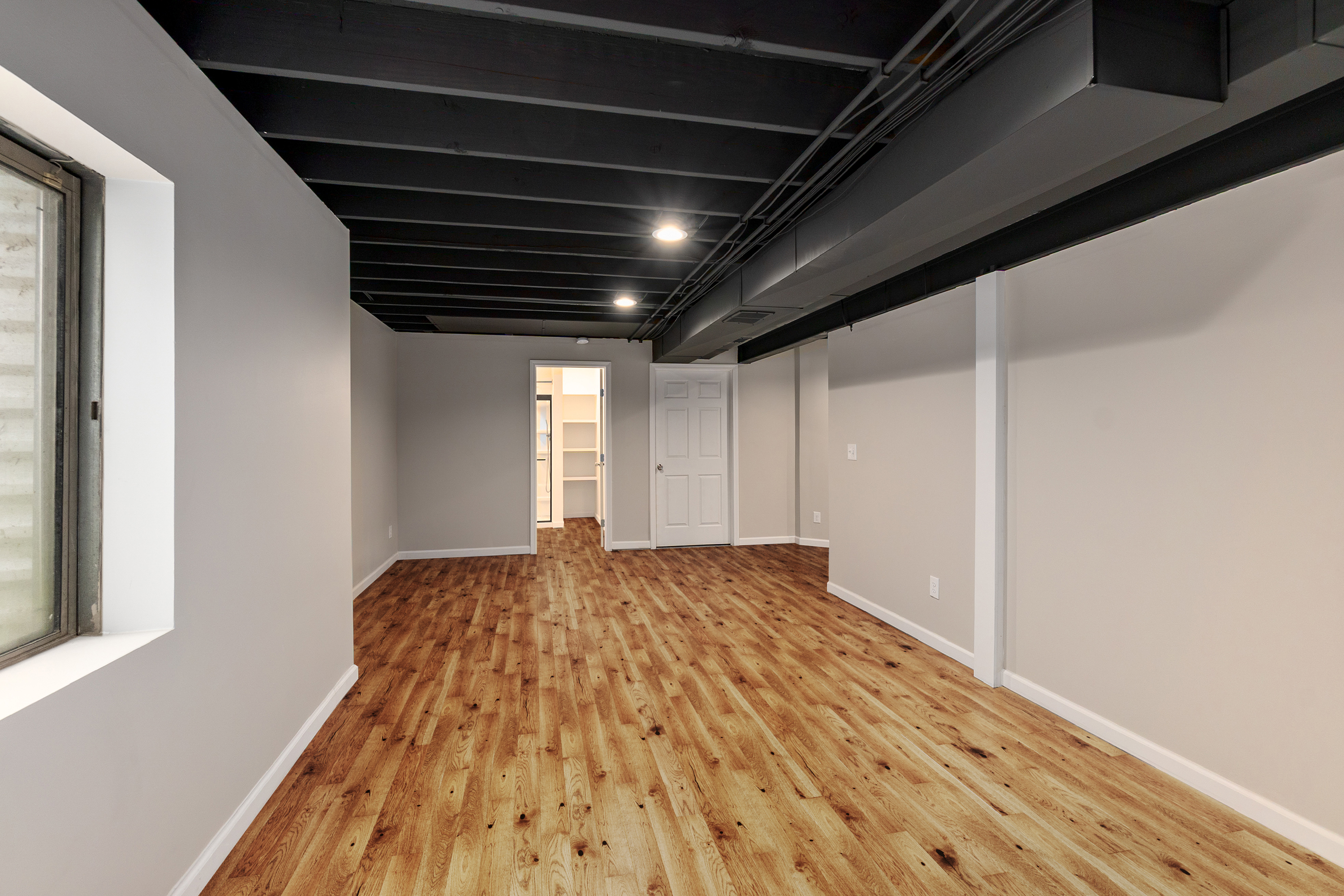 Finished basement hallway leading to additional finished space