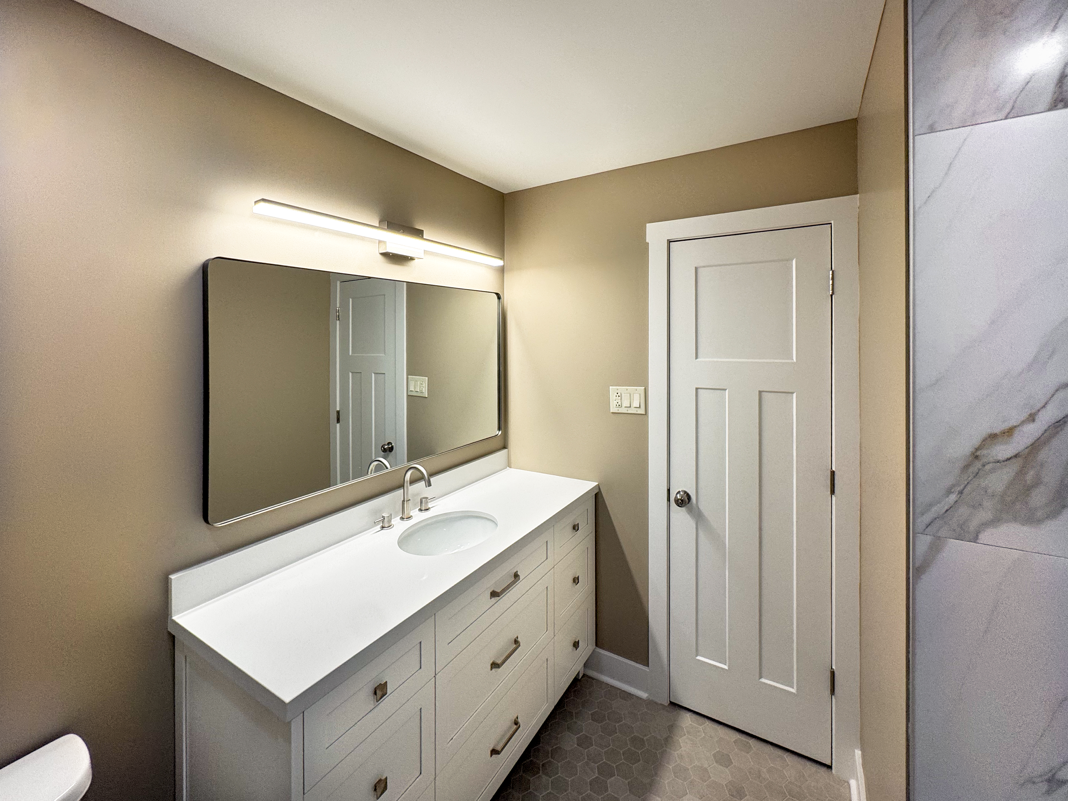Finished vanity with quartz countertop and mirror