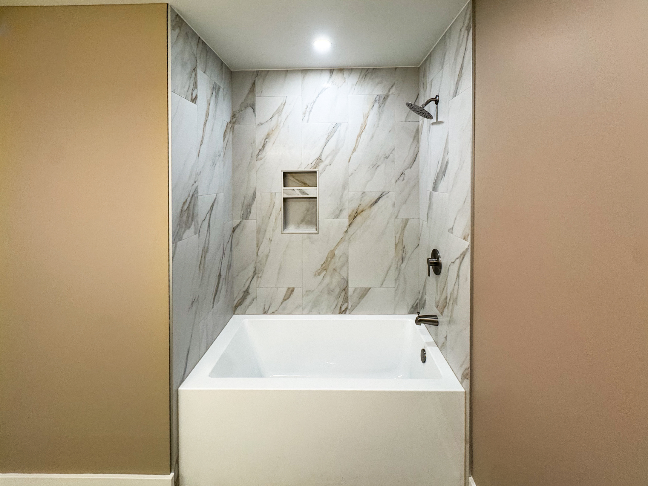 Finished tub and shower surround with marble-look tile