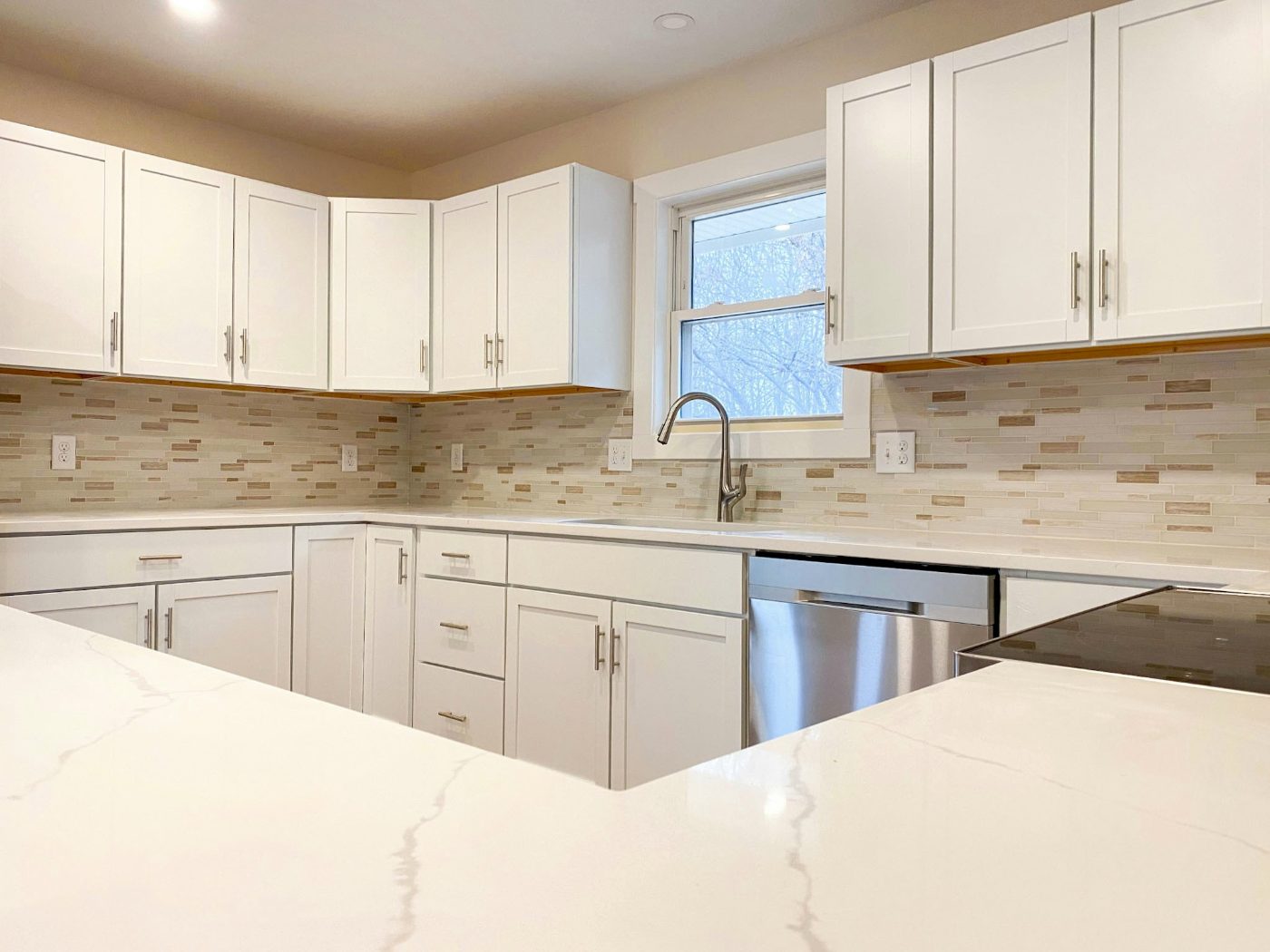 Remodeled kitchen with white cabinetry