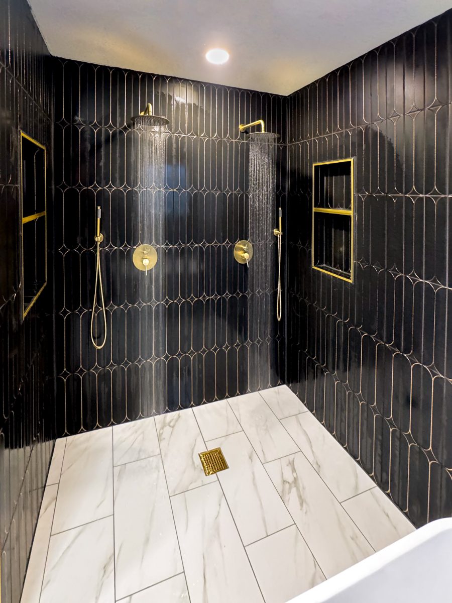 Custom black tile shower with brass fixtures